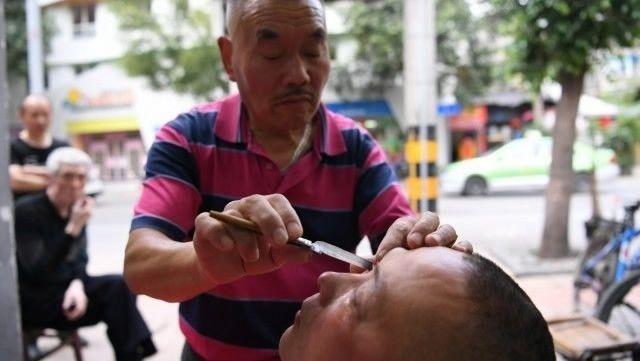 Престарелый китаец чистит глаза всем желающим опасной бритвой